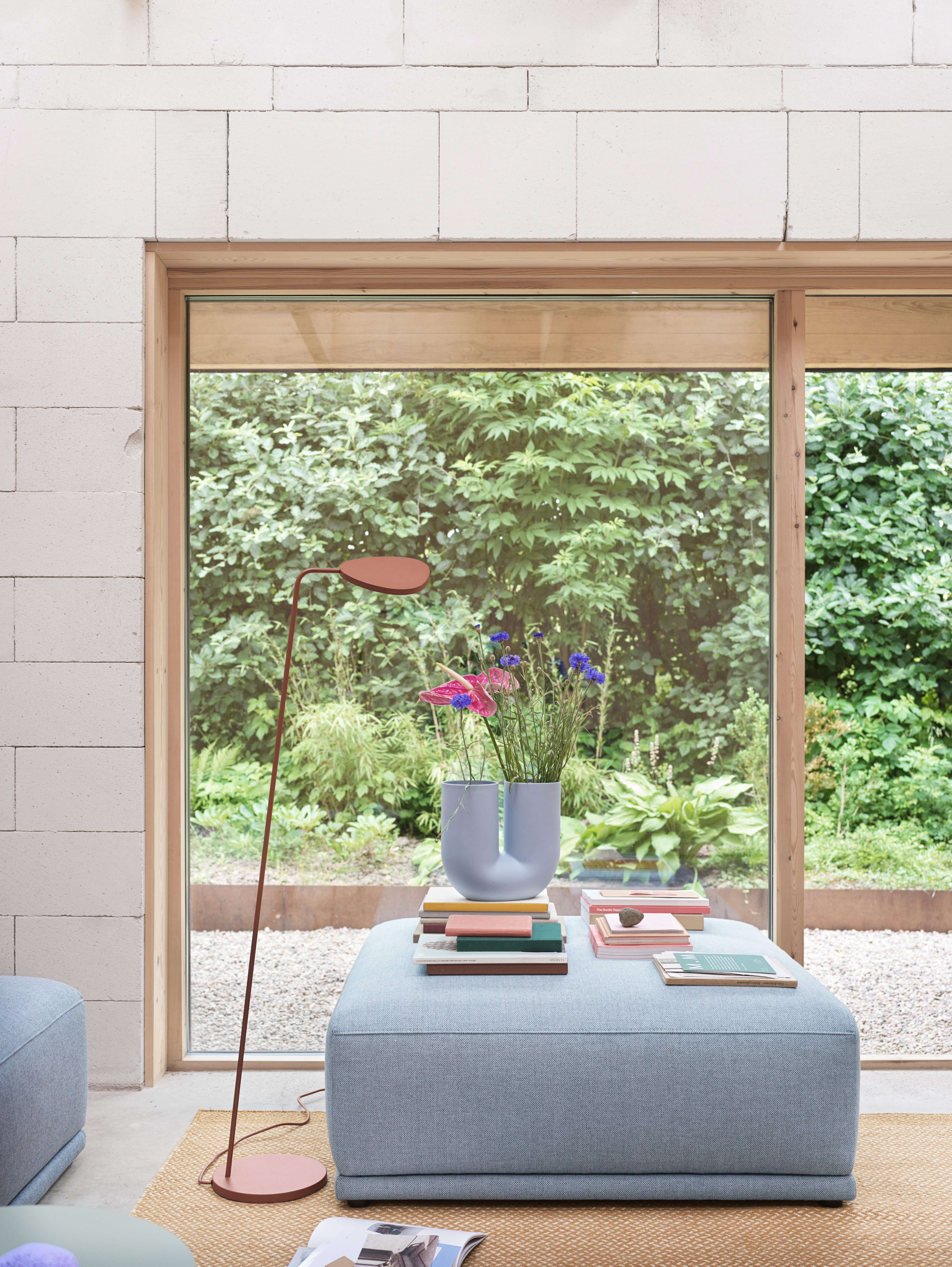 Interior setting featuring the Connect Soft Modular Sofa in Re-wool 718, Kink Vase in light blue, Leaf Floor Lamp in copper brown, and Ply Rug in burnt orange. A warm and modern composition by Muuto.