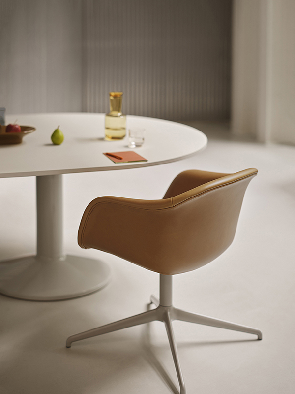Refined cognac leather Fiber soft Armchair on a chrome swivel base, paired with a grey Midst conference table with power. Ideal for professional or meeting spaces.