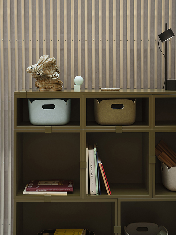 The brown-green Stacked storage system, paired with Restore Baskets, offers a stylish and functional solution for organizing your space in a modern, minimalist way